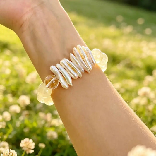Woman wearing a natural baroque pearl and citrine crystal bracelet