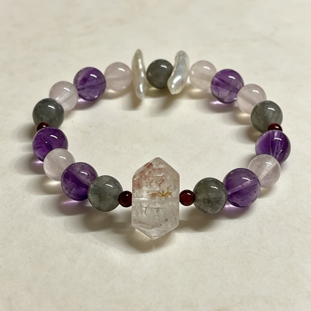 Red phantom quartz double terminated crystal detail with natural inclusions