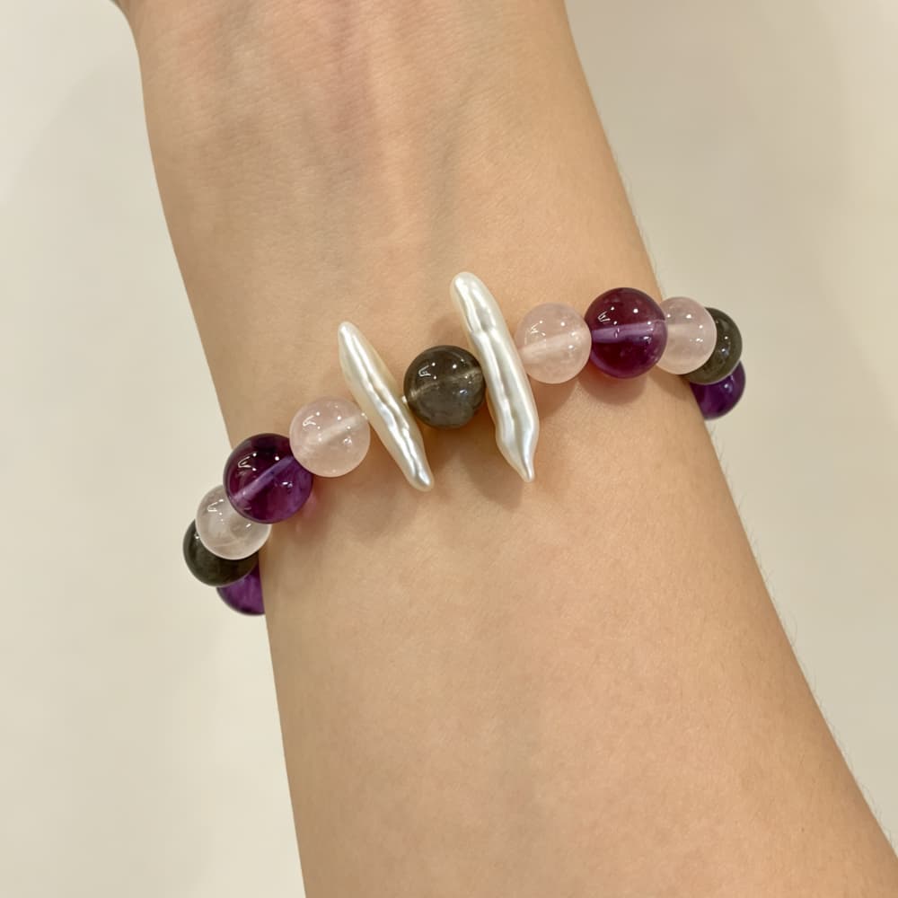 Woman wearing Moonlit Serenity natural crystal bracelet on her wrist