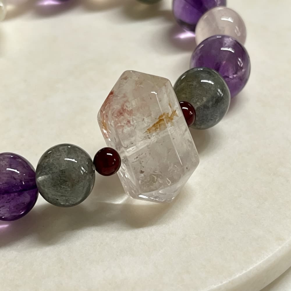 Red phantom quartz double terminated crystal detail with natural inclusions